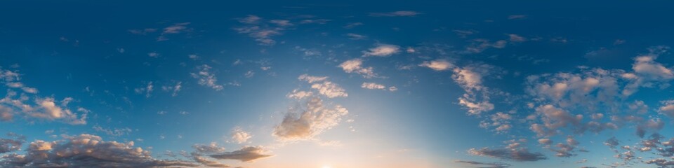 Fototapeta premium Sky panorama clouds over a serene sunset horizon with beautiful blue and orange gradients and copy space