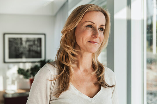 Blonde woman portrait indoors with confident and happy expression
