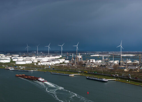 Refinery and wind turbine at Rotterdam harbor during a storm