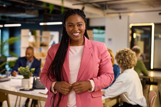 Portrait of smiling black curvy businesswoman looking at camera