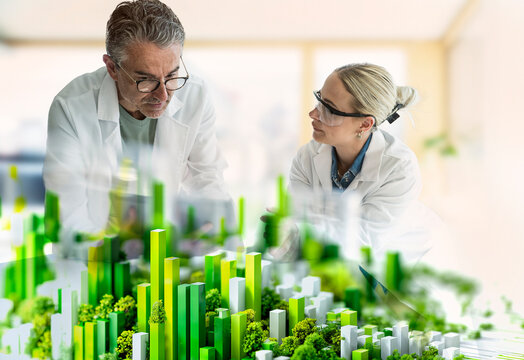 Scientists collaborating on sustainable green energy city model
