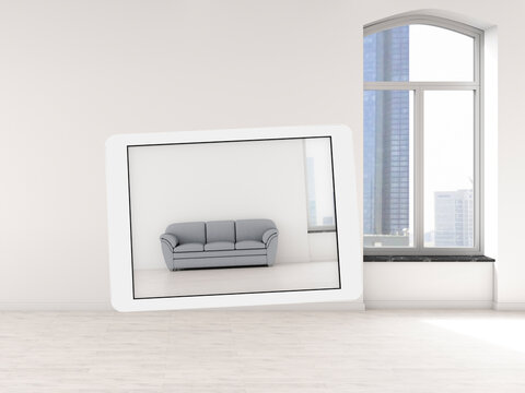 Tablet displaying 3D rendering of sofa in an empty modern loft