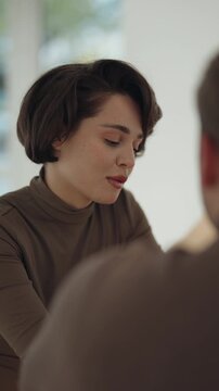 Smiling Young Woman With Short Hair Engaged in a Happy Conversation