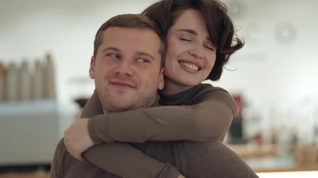 Happy Couple Sharing a Loving Embrace, Smiling and Laughing Together in a Tender Moment