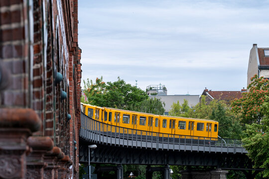Urban transit infrastructure in berlin frames a metro train on viaduct bridge creating layered cityscape lines and everyday transport flow