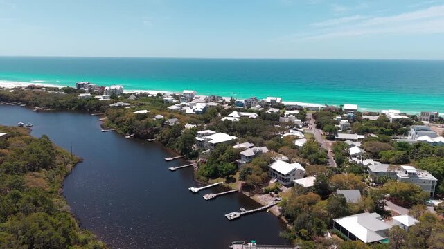 Drone orbit over Big Redfish Lake and the Blue Mountain Beach resort area with residential luxury homes, Santa Rosa Beach, Florida, USA