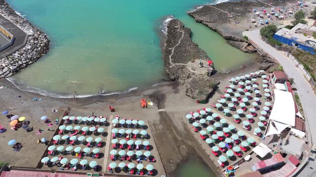 beach club and luxury European lifestyle of Castiglioncello, Italy. Warm turquoise waters beckon sun worshippers into the Mediterranean Sea