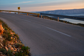 Fototapeta premium A dramatic winding road on the island of Hvar, bathed in the light of the rising sun