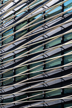 Diagonal movement shapes this glass architecture facade where modern lines and reflections build an abstract pattern with rich texture