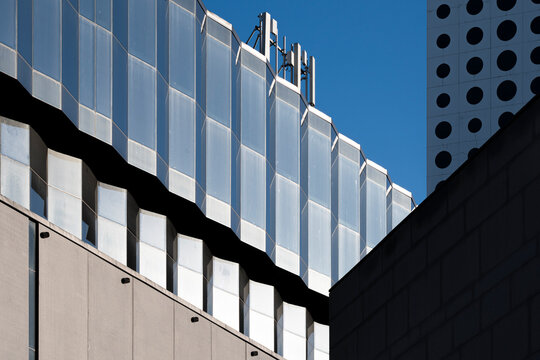 Rooftop lines and concrete planes shape a modern building where architecture facade and glass create abstract geometry in perspective