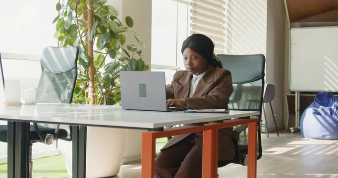 Analyst thoroughly inspecting performance figures in vibrant office setting