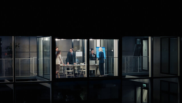Executives Work Late in a Glass Office, Reviewing Performance Dashboards, Aligning Budgets, Prioritizing Initiatives, and Coordinating Cross-functional Projects While Planning Next-quarter Growth