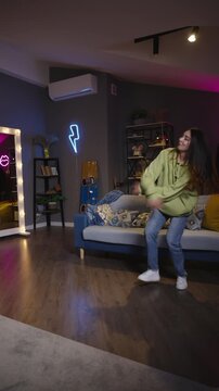 Teen girl dancing at home while friend records video modern youth lifestyle and creative expression concept