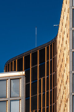 Curved lines shape geometric detail on modern minimal architecture facade against blue sky creating clean contemporary background for designers
