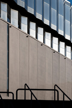 Gray windows and shadow on modern minimal architecture facade show geometric lines detail creating clean contemporary background for web design