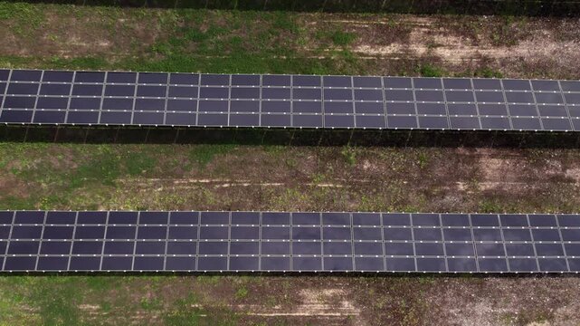 Aerial drone view of a solar panel farm producing clean energy