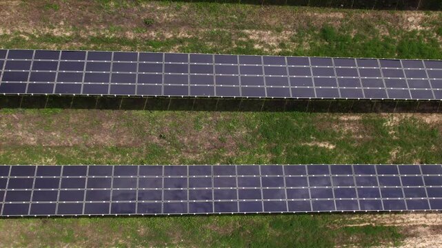 Drone flying over solar panels at a renewable energy farm