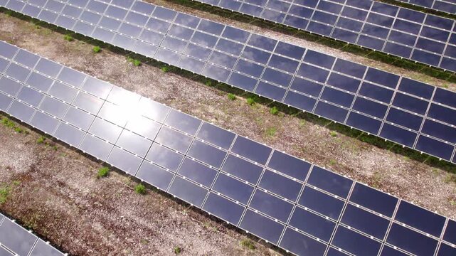 Drone flying over a solar panel farm for green energy