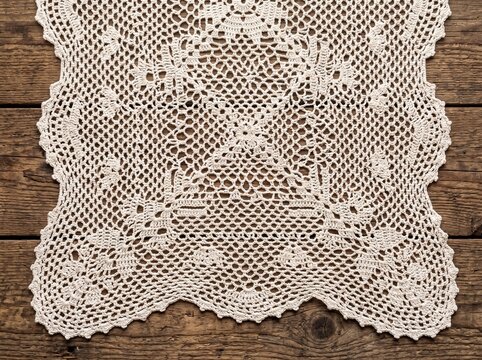 Lace Crocheted Doily on a Rustic Wooden Table Background for Natural Design Branding