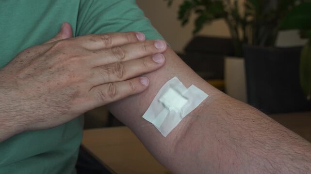 Removing Bandage from Arm After Blood Test