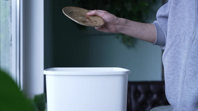 Discarding leftover cake, reducing food loss awareness. Man throwing away leftover cake, quitting sugar concept