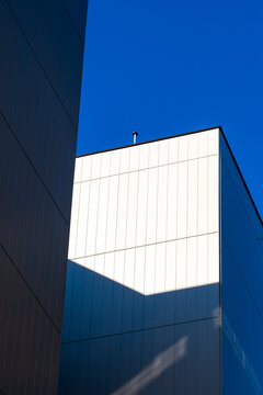 Modern architecture abstract facade with blue geometry shadow and sunlight shaping a minimalism composition of quiet planes and contrast