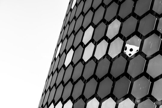Modern architecture abstract facade built from hexagon pattern and monochrome geometry with glossy texture creating graphic detail