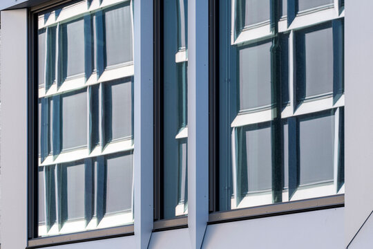Modern architecture abstract window facade where blue reflection and geometry line define an ordered frame with elegant surface detail