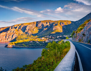Fototapeta premium Colorful summer view of empty asphalt road to Acquafredda resort. Captivating morning scene of Italy, Europe. Beautiful summer seascape of Mediterranean sea. Traveling concept background.