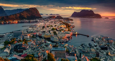 Dramatic summer view from flying drone of Alesund port. Fantastic sunset in west coast of Norway, at the entrance to the Geirangerfjord. Traveling concept background. © Andrew Mayovskyy