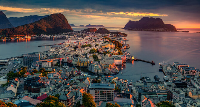 Dramatic summer view from flying drone of Alesund port. Fantastic sunset in west coast of Norway, at the entrance to the Geirangerfjord. Traveling concept background.
