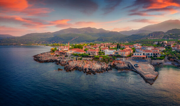Colorful summer cityscape of Kardamyli port. Marvelous morning seascape of Mediterranean sea. Spectacular sunrise on Peloponnese peninsula, Greece. Traveling concept background.