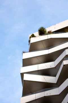 White balcony lines lift a minimal modern residential architecture facade into Paris France sky with elegant apartment design clarity