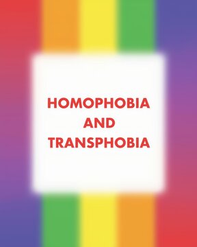 Homophobia and transphobia text sign on a colorful rainbow pride background representing equality and social awareness for the lgbtq community rights