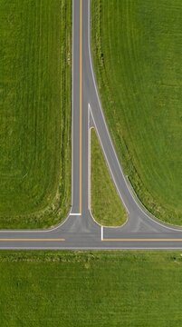 Aerial top down view of rural road intersection and fields