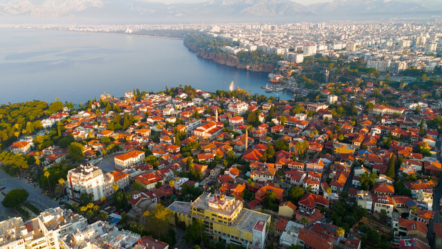Antalya, Turkey. Aerial drone panorama of Kaleici Old Town, yacht marina, Mediterranean Sea and Taurus Mountains backdrop in morning light.. Aerial View