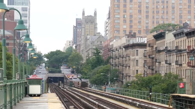 New York City Upper Manhattan subway outdoor station platform, 125 street elevated metro in Harlem, United States railway. Residential district public metropolitan transport. Lanterns and buildings.