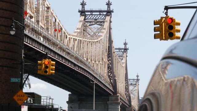 New York City Manhattan Midtown, Queensboro bridge architecture in United States. Urban transport bridge over East River. Yellow traffic light under metallic bridge in East Side. First 1st avenue.