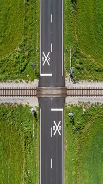 Top down aerial view of rural railroad crossing and road