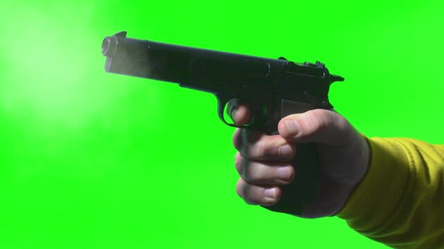 Gun shot effect on green screen with hand holding an empty pistol chroma key