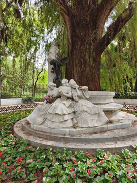 Marble sculpture of women with flowers in Parque Maria Luisa, Seville, Spain