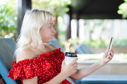 Upset Unhappy Frustrated Middle aged Caucasian aunt, aged woman using smartphone, negative expression, concept image for slow connection, internet scam, internet fraud, poor cyber security