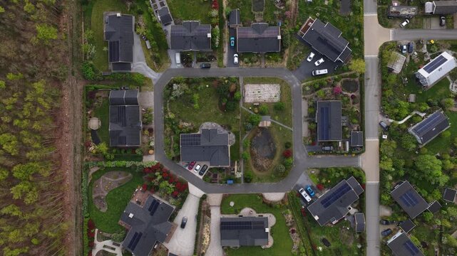 Drone view of eco village Bolderburen between Almere and Zeewolde, showing wooden homes, gardens, orchard, Scandinavian style, and sustainable community living.