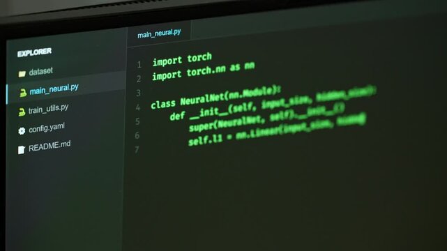 Programming computer code on screen in software development process.