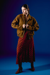 Obraz premium Stylish young woman showcases bold fashion in a vibrant urban setting with creative flair