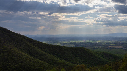 Fototapeta premium Sun Rays Breaking Through Clouds Over Valley Landscape in Shenandoah National Park