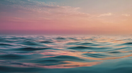 Fototapeta premium Pastel ocean waves at sunset against a soft pink sky and a calm sea horizon, a minimalist seascape