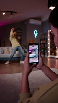 Rhythmic dance clip style breakdance hip hop performance recorded on phone in youth home interior