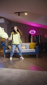 Young dancer recording expressive hip hop routine at home youth lifestyle concept