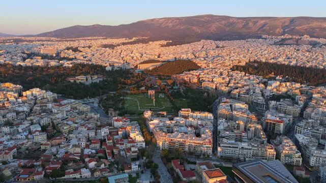 Aerial video of Athens at Sunset featuring the National Garden, Temple of Apollo Delphinius and the Acropolis. 